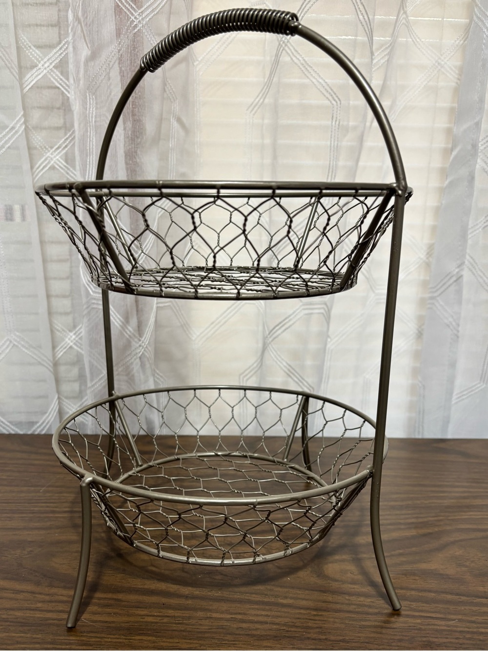 2-tier basket made of metal w/chicken wire design antiqued color. 9” bowls 13”H